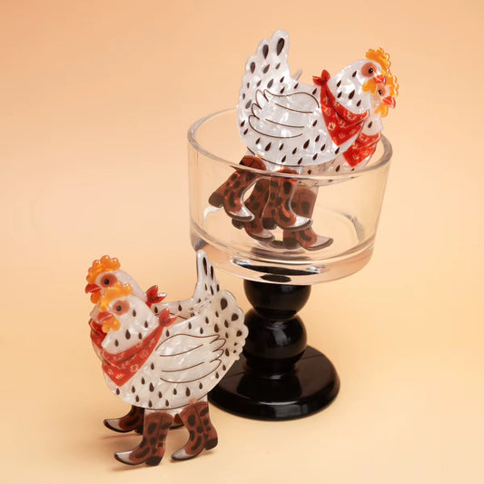Two chicken claw clips with cowboy boots displayed on a glass stand, cute western hair clip gift